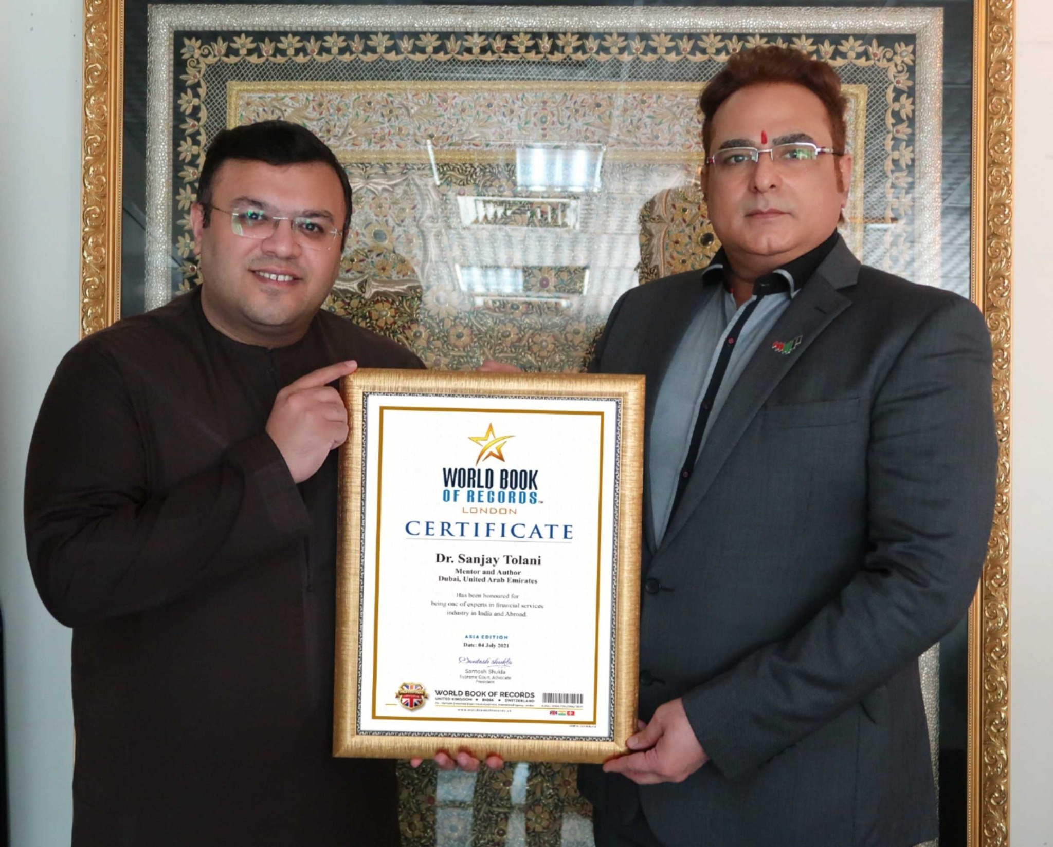 Dr. Sanjay Tolani receiving a World Book of Records certificate